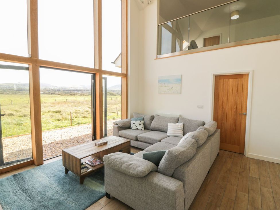 A living room with a sofa and coffee table at Cae Mawr in Caernarfon