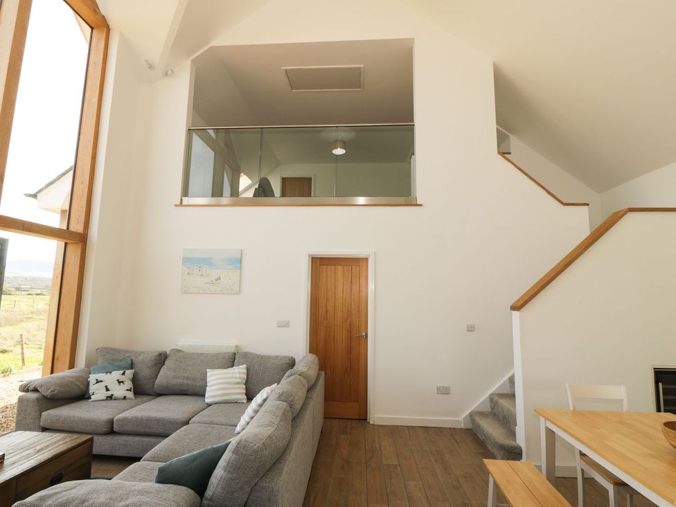 A living room with a sofa and a table at Cae Mawr in Caernarfon