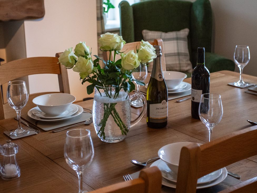A dining room table set with wine and bowls at Gap Farm in Brampton