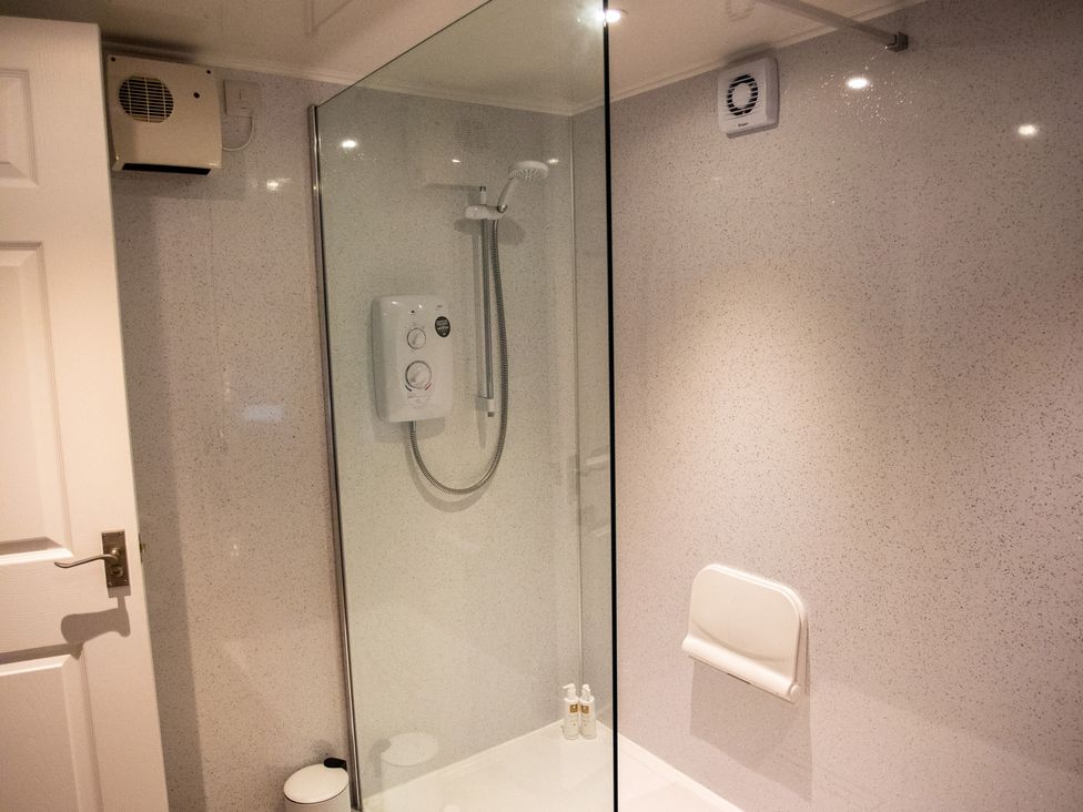 A shower area with a glass enclosure at Gap Farm in Brampton