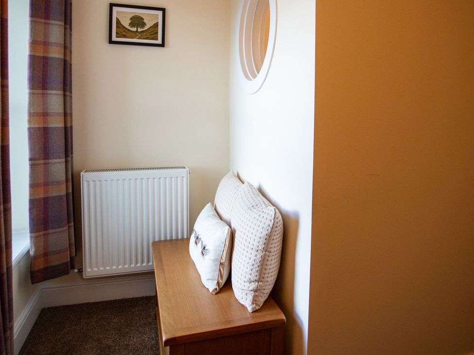 A living room with a sofa and a radiator at Gap Farm in Brampton
