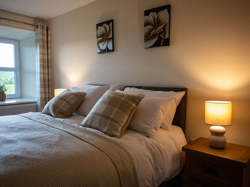A bedroom with a bed and bedside table at Gap Farm in Brampton