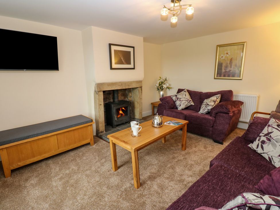 A living room with a sofa and coffee table at Gap Farm in Gilsland