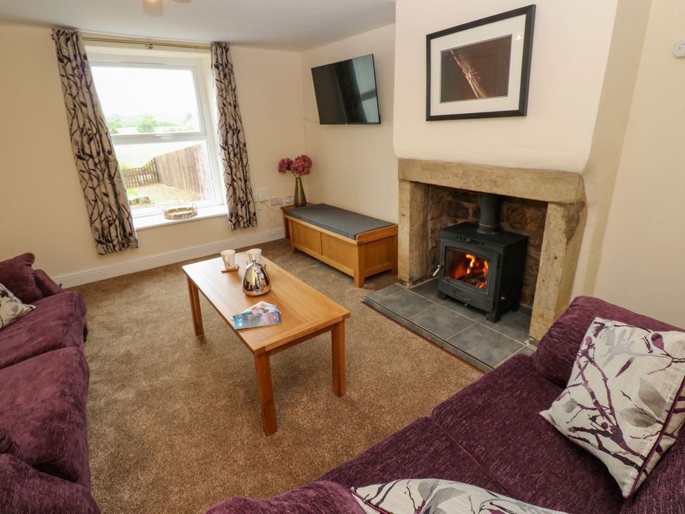 A living room with a sofa and coffee table at Gap Farm in Gilsland