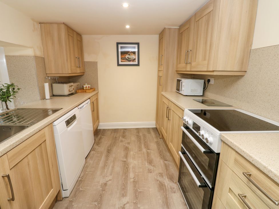 A kitchen with cabinets and appliances at Gap Farm in Gilsland