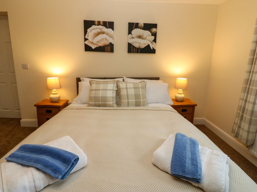 A bedroom with a bed and bedside lamps at Gap Farm in Gilsland