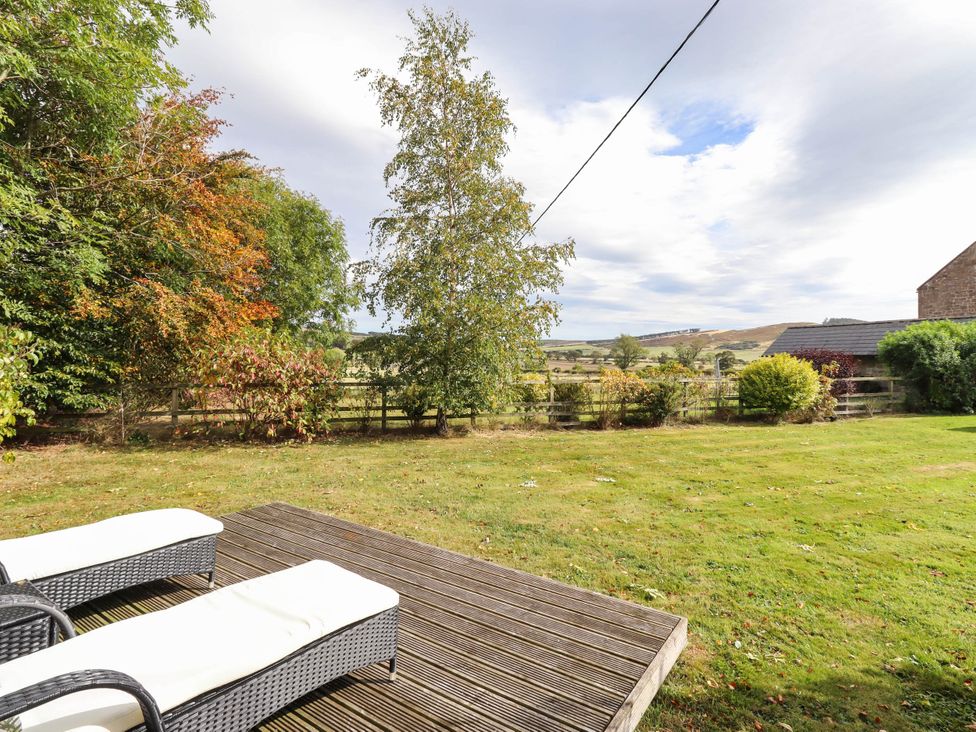 A garden with decking and loungers at The Gables in Alnwick