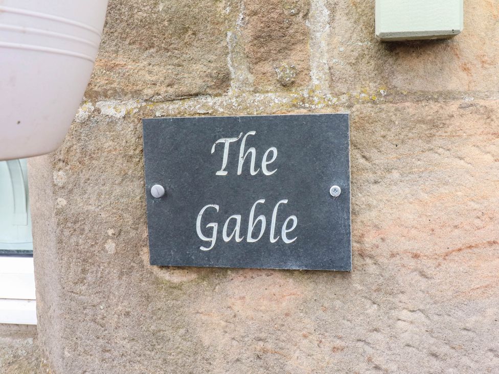 A nameplate on a stone wall at The Gables in Alnwick