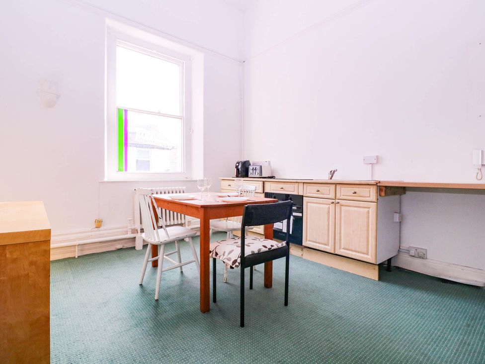 A kitchen with a table and chairs at 6 Caxton Place Newport, South Wales