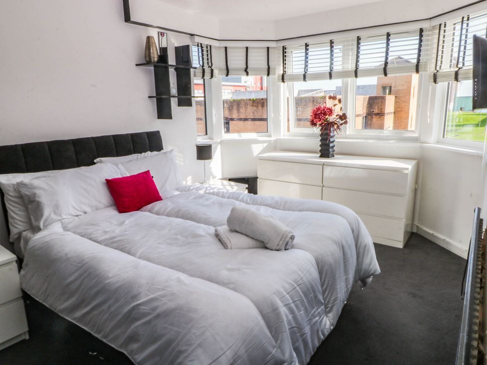 A bedroom with a bed and a chest of drawers at 21 Ferrara Square Swansea