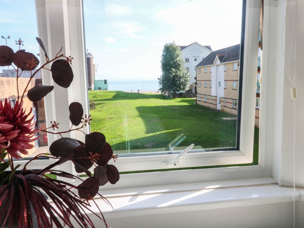 A view from a window showing grass and buildings at 21 Ferrara Square Swansea