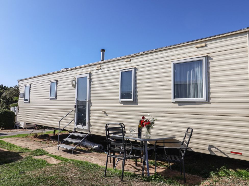 A trailer with a table and chairs outside at Spruces 30 Sandy Bay, Exmouth