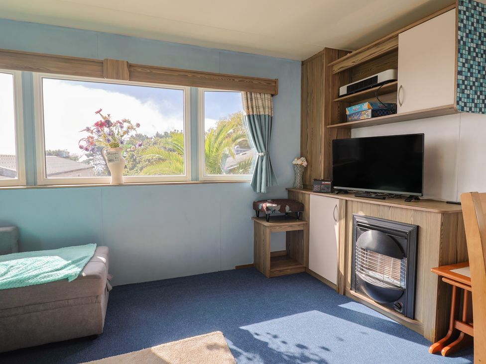 A snug with a sofa and television at Spruces 30, Sandy Bay, Exmouth