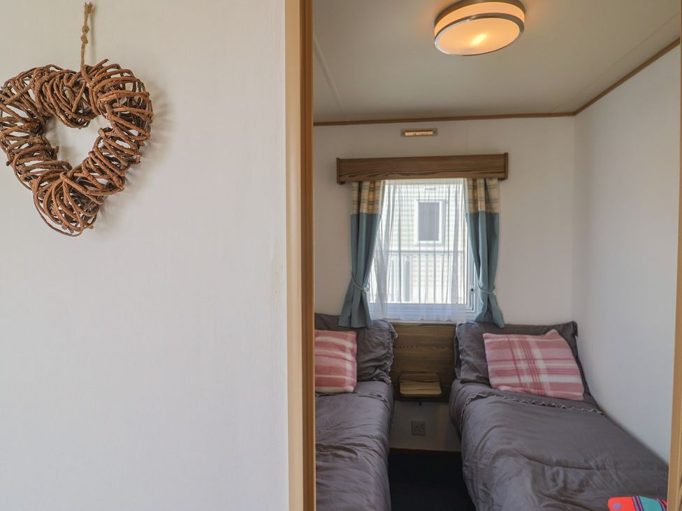 A bedroom with two beds and a heart decoration at Spruces 30 Sandy Bay, Exmouth