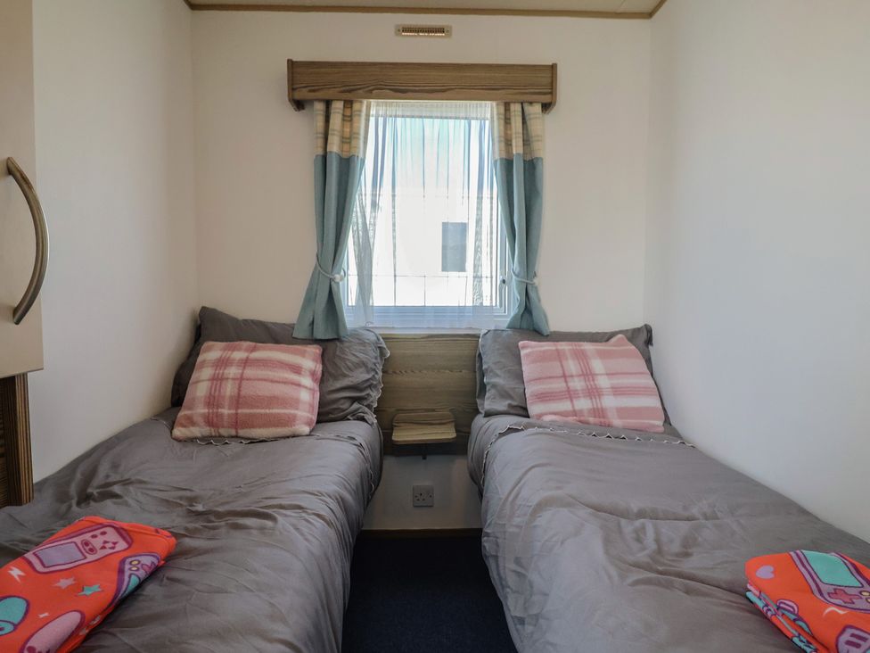 A bedroom with two beds and a window at Spruces 30, Sandy Bay, Exmouth
