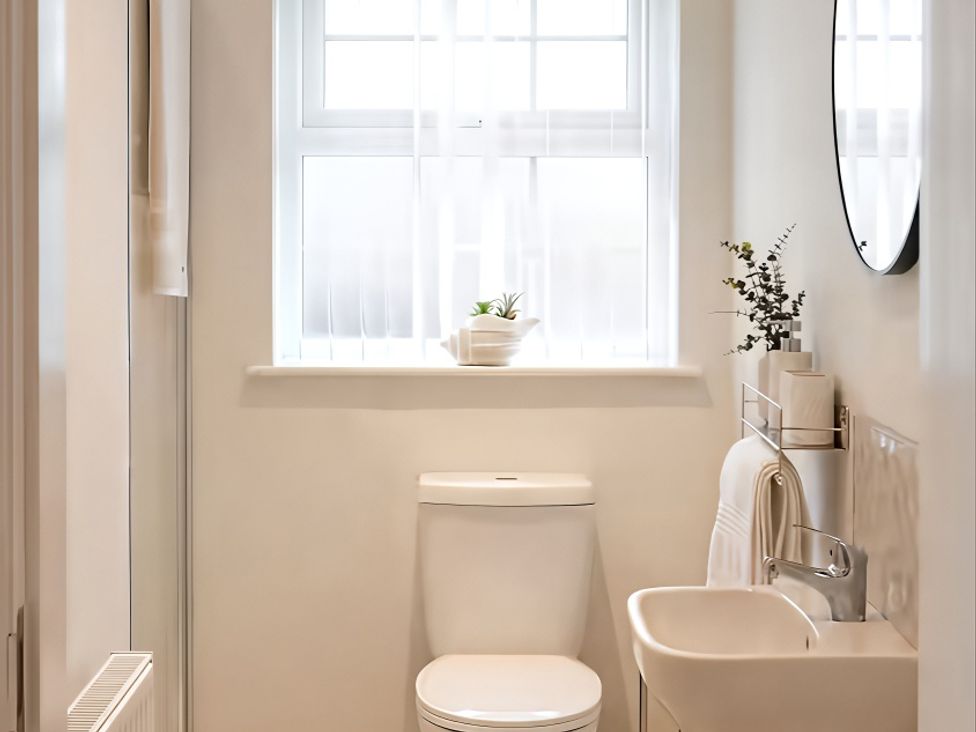 A bathroom with a sink and toilet at Long Meadow Apartment in Portglenone