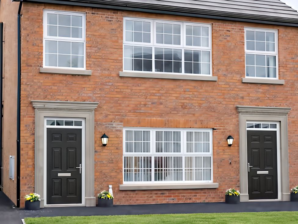 An exterior view of a house with two entrances at Long Meadow Apartment in Portglenone