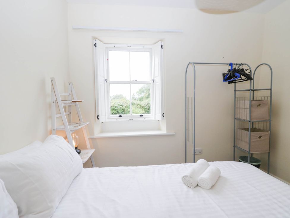 A bedroom with a bed and storage items at Holly in Cleator