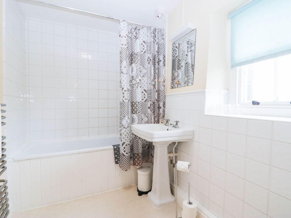 A bathroom with a bathtub and sink at Holly in Cleator