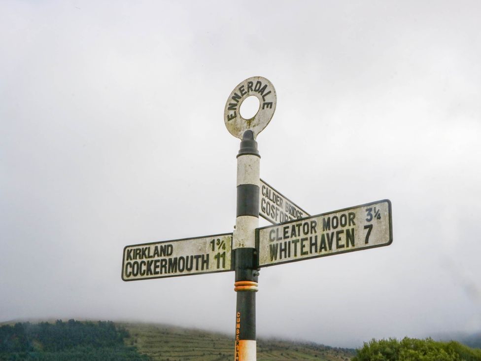 A signpost indicating directions to various locations at Ennerdale in Cleator