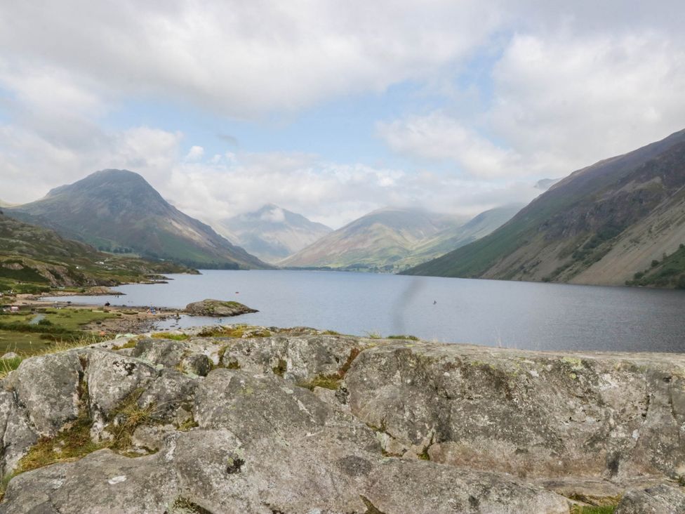 A view of a lake surrounded by mountains at Holly in Cleator