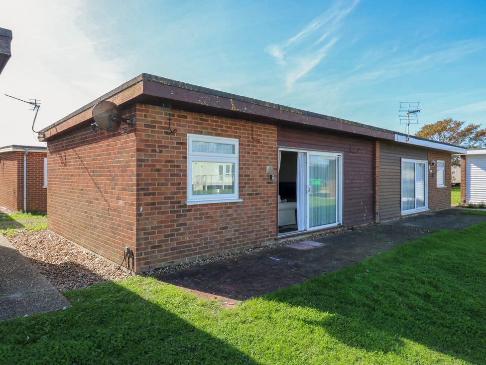 An outdoor view of a building with windows and grass at 110 Bay View in New Romney