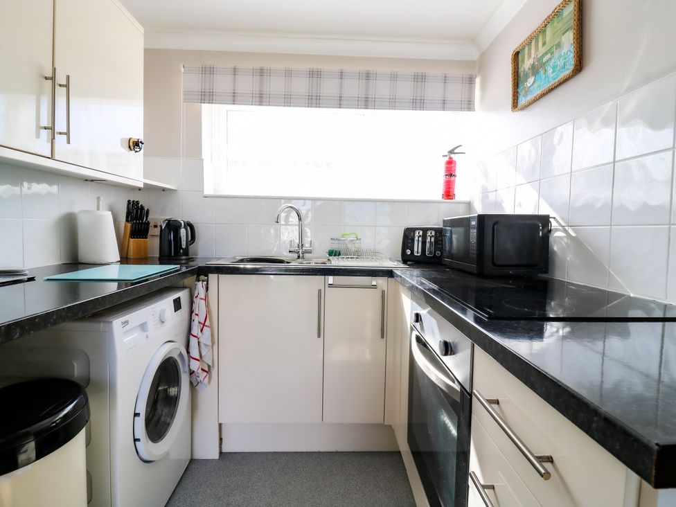 A kitchen with appliances and a sink at 110 Bay View in New Romney