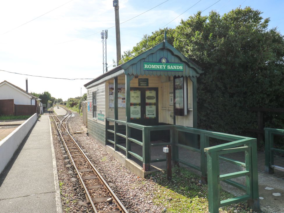 A ticket office at a train station with tracks at Romney Sands in New Romney
