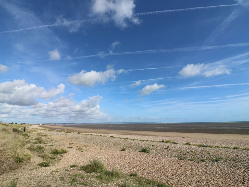 A beach with pebbles and water at 110 Bay View in New Romney