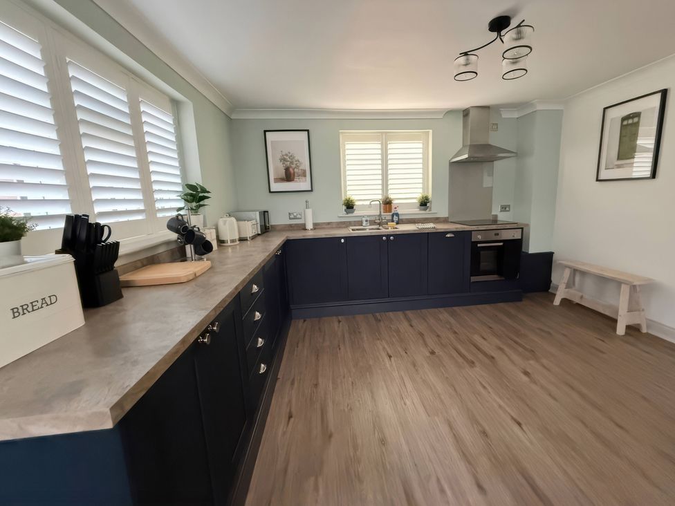A kitchen with countertops, cabinets, sink, and an oven at Ridings Annex in Tonbridge