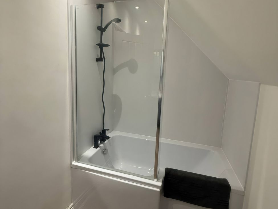 A bathroom with a bathtub and shower at Ridings Annex in Tonbridge