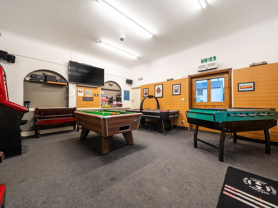 A recreation room with a pool table and foosball table at The Half Boar in Bishop's Castle