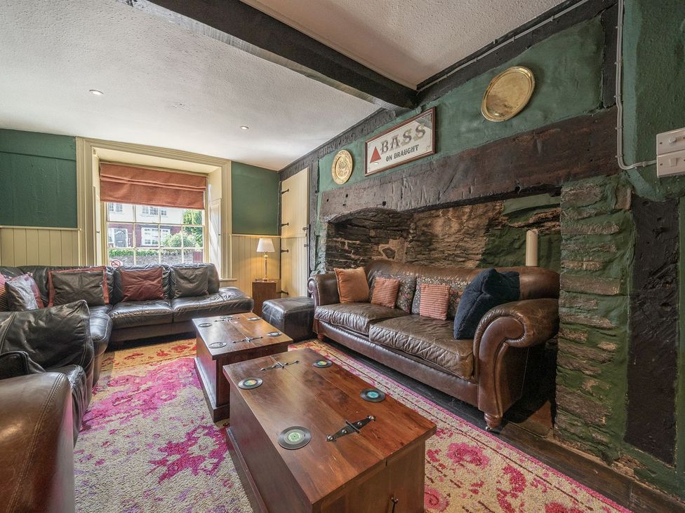 A living room with a sofa and coffee table at The Half Boar in Bishop's Castle