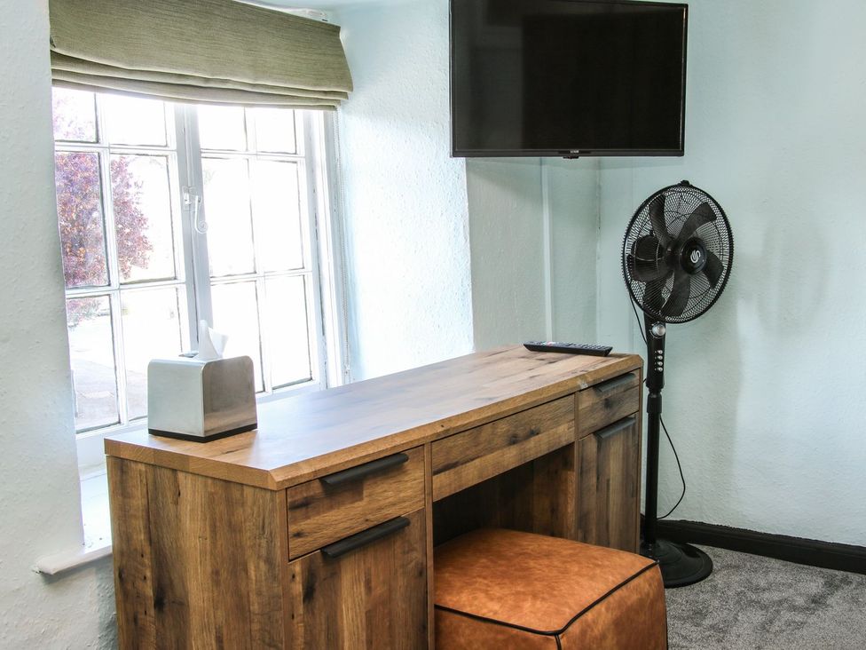 An office with a desk and a television at The Half Boar in Bishop's Castle