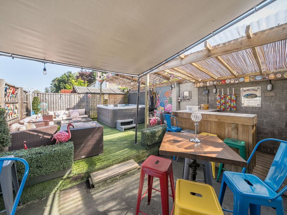A garden with seating and a hot tub at The Half Boar in Bishop's Castle