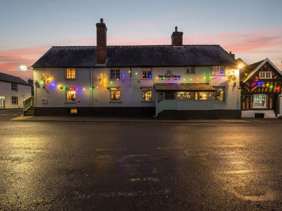A pub building with decorative lights at The Half Boar in Bishop's Castle