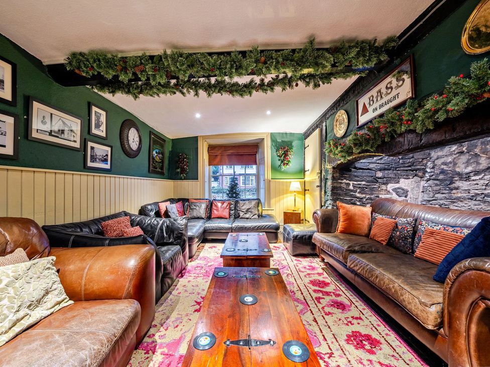 A living room with a sofa and coffee table at The Half Boar in Bishop's Castle
