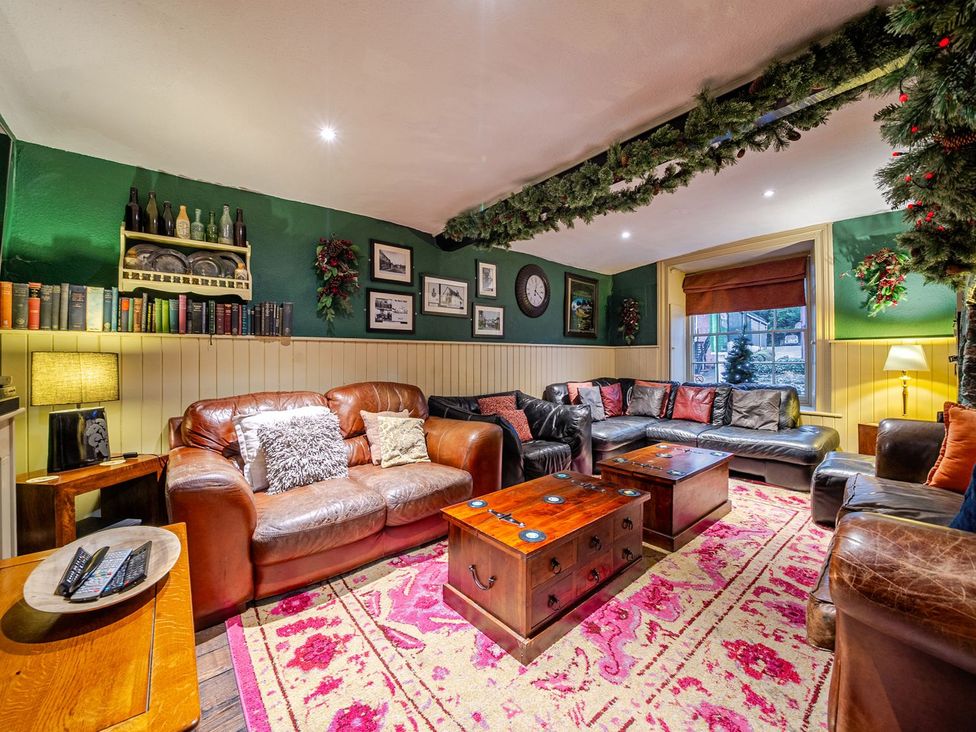 A living room with a sofa and coffee table at The Half Boar in Bishop's Castle