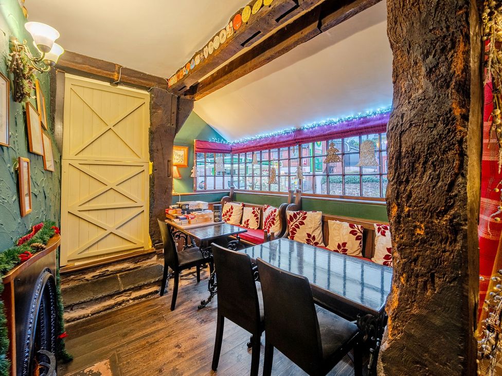 A dining room with a table and chairs at The Half Boar in Bishop's Castle