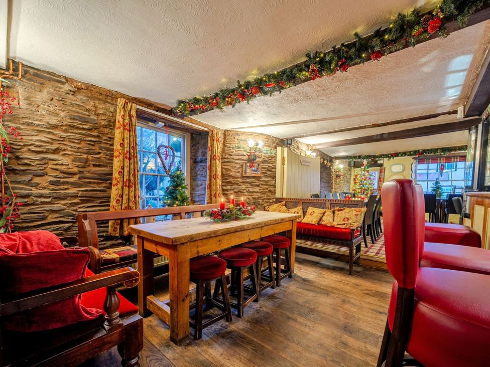 A dining room with a table and chairs at The Half Boar in Bishop's Castle