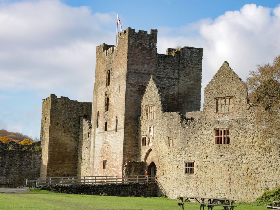 A castle with a tower and walls at The Half Boar in Bishop's Castle