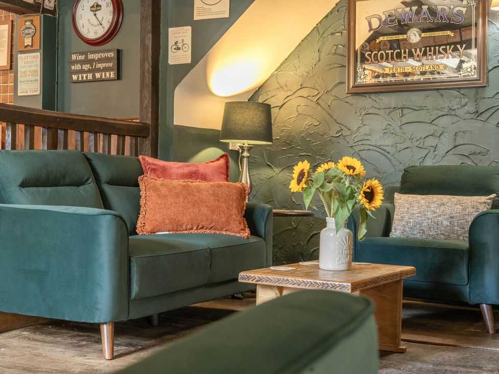 A living room with a sofa and coffee table at The Half Boar in Bishop's Castle
