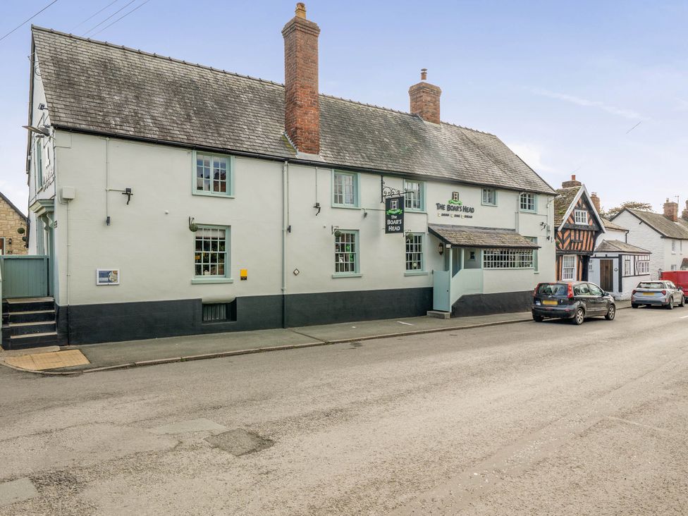 A building with signage and windows at The Half Boar in Bishop's Castle