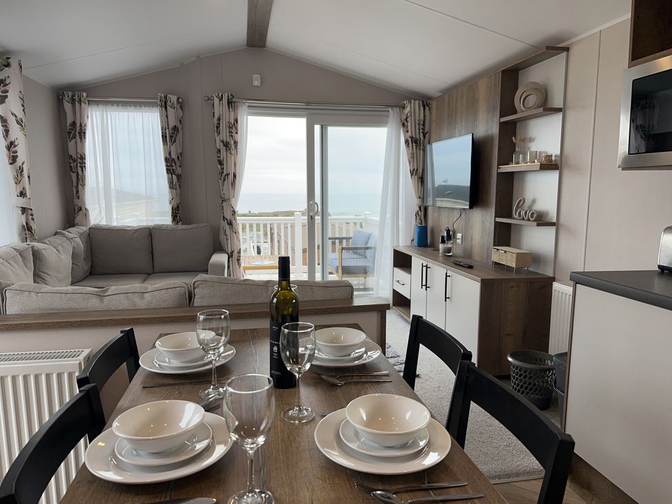 A living room with a sofa and dining table at Club Sahara Sandy Bay, Exmouth