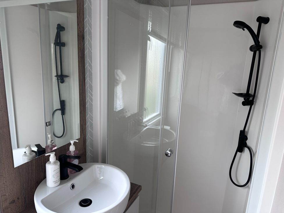 A bathroom with a sink and shower at Club Sahara Sandy Bay, Exmouth