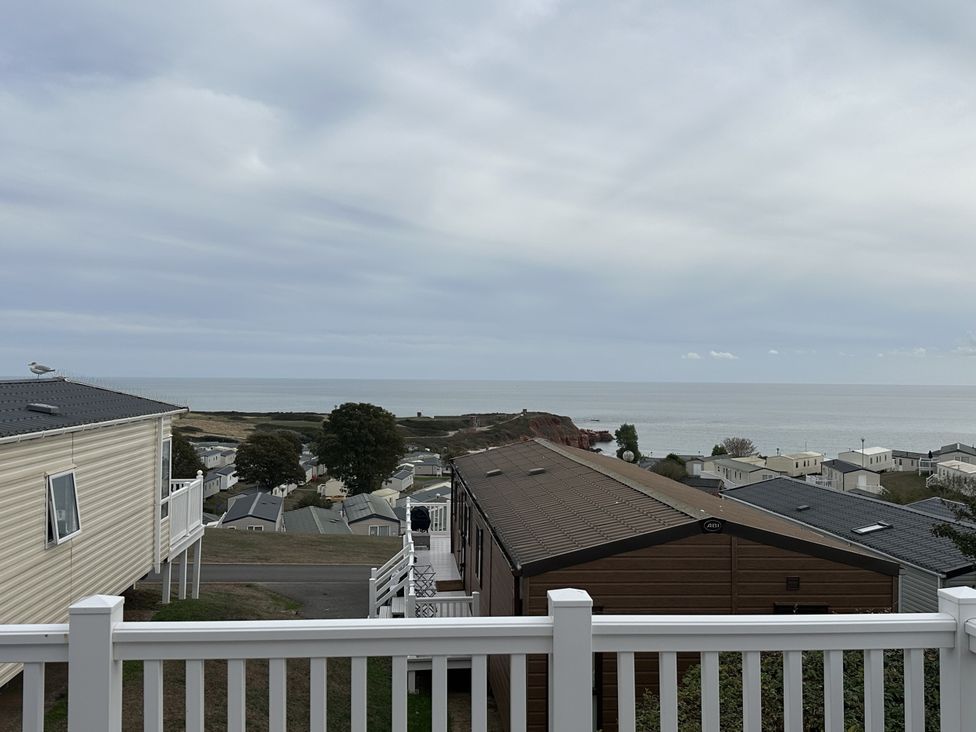 A view of houses and the sea from a deck at Club Sahara in Sandy Bay, Exmouth