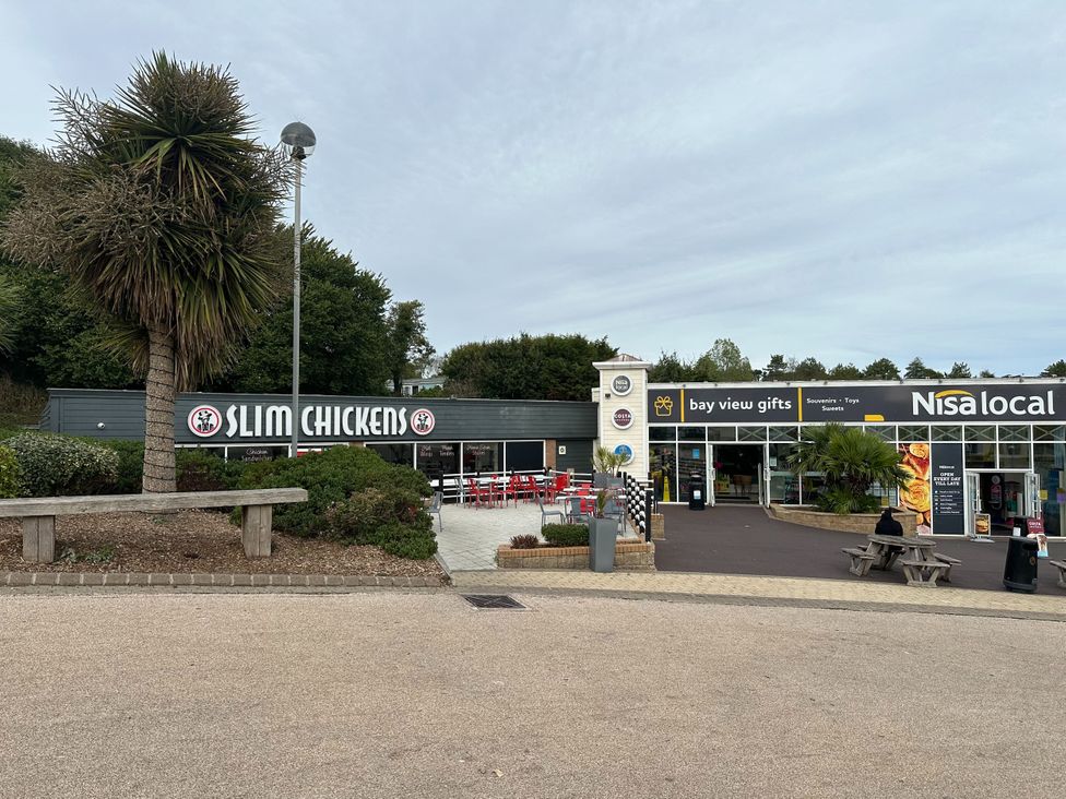 An outdoor area with Slim Chickens and Nisa local at Club Sahara Sandy Bay Exmouth