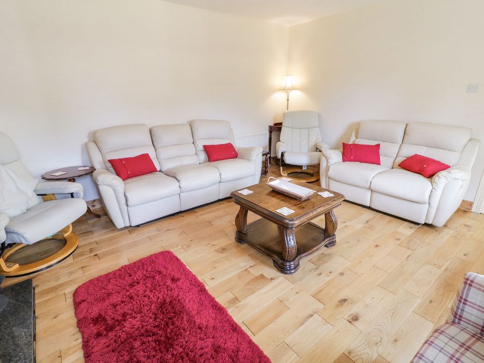 A living room with sofa and coffee table at Craiglea Lodge in Coleraine