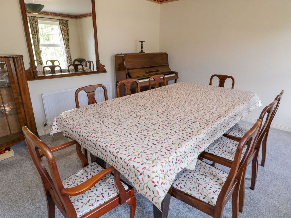 A dining room with a table and chairs at Craiglea Lodge in Coleraine