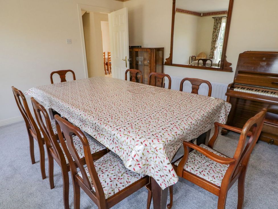 A dining room with a table and chairs at Craiglea Lodge in Coleraine
